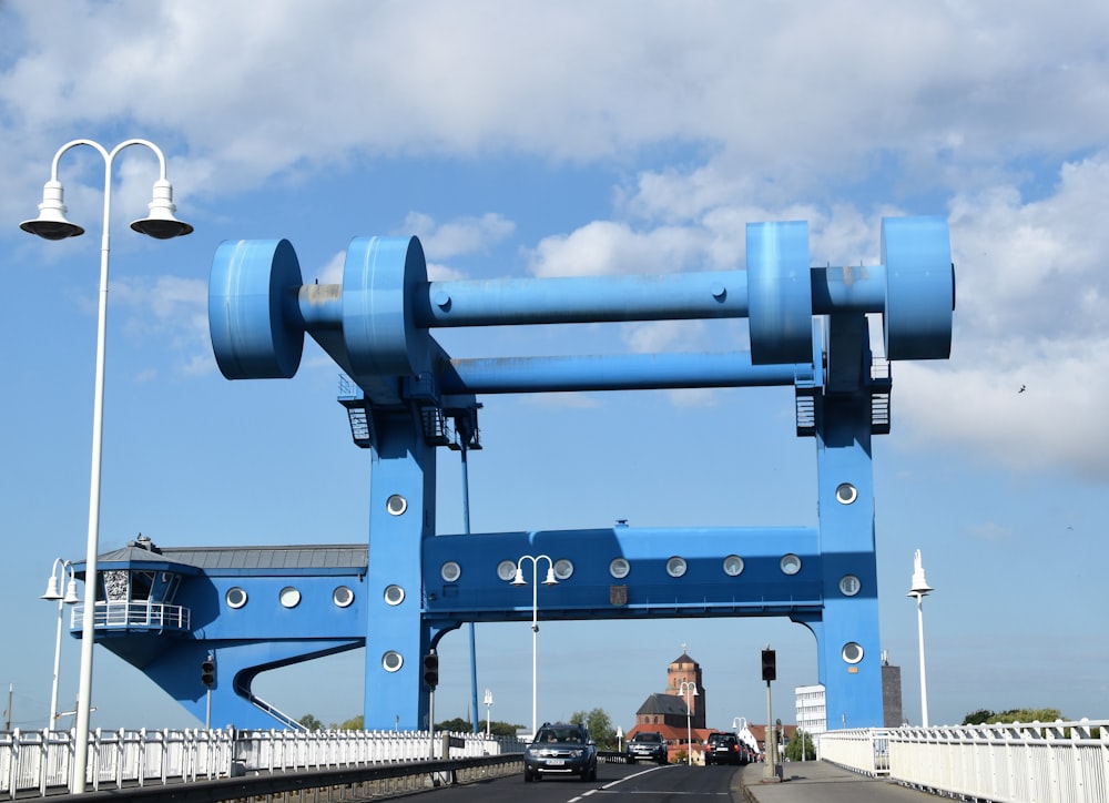 people standing near blue metal tower