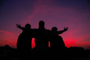 silhouette of man and woman standing during sunset