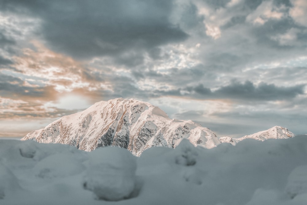 snow covered mountain under cloudy sky during daytime