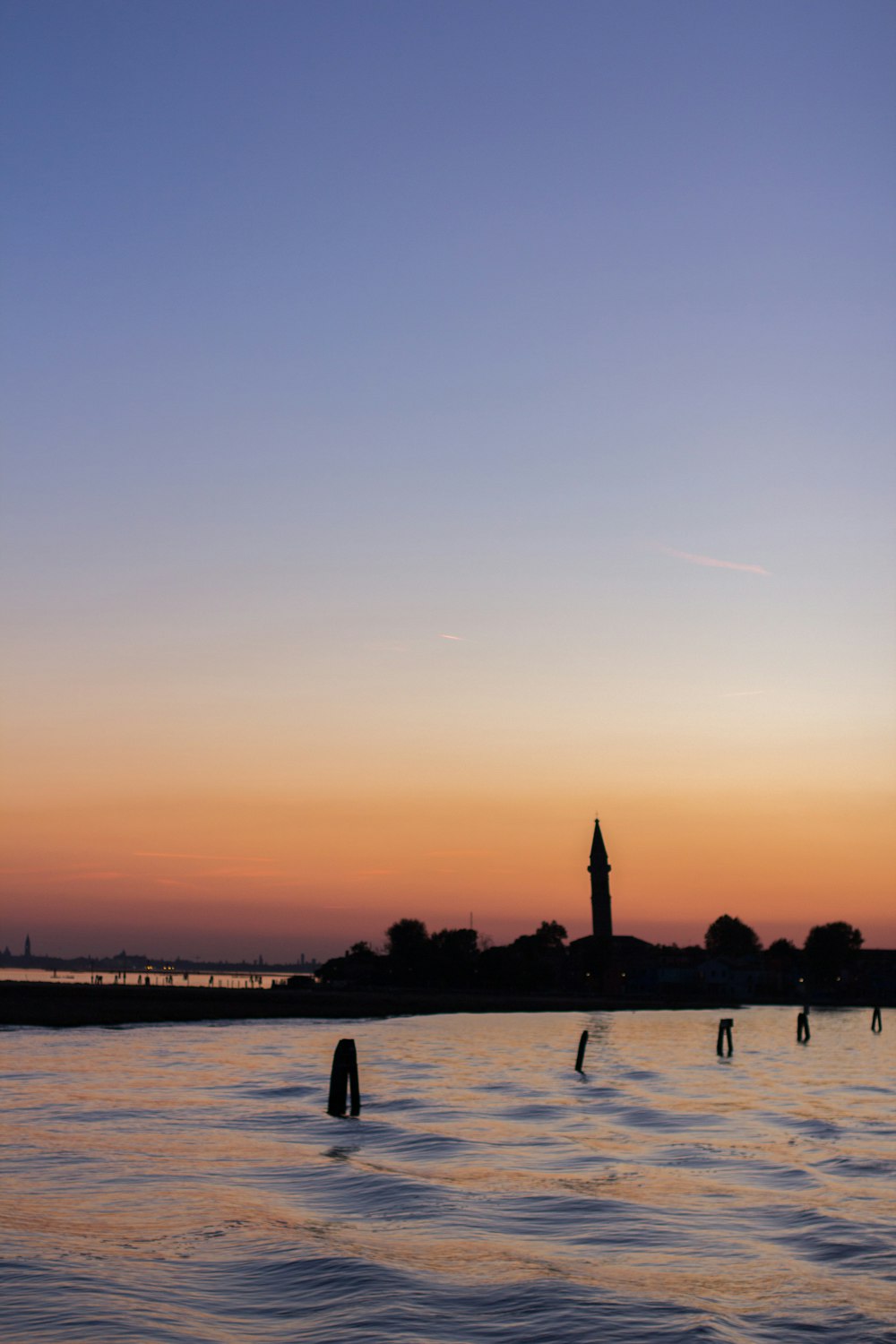 silhouette of people on beach during sunset