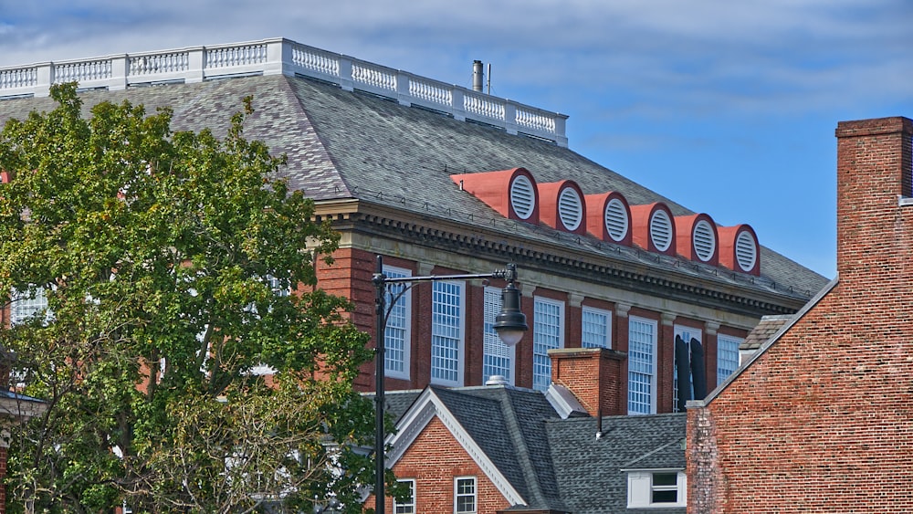 brown brick house with green trees