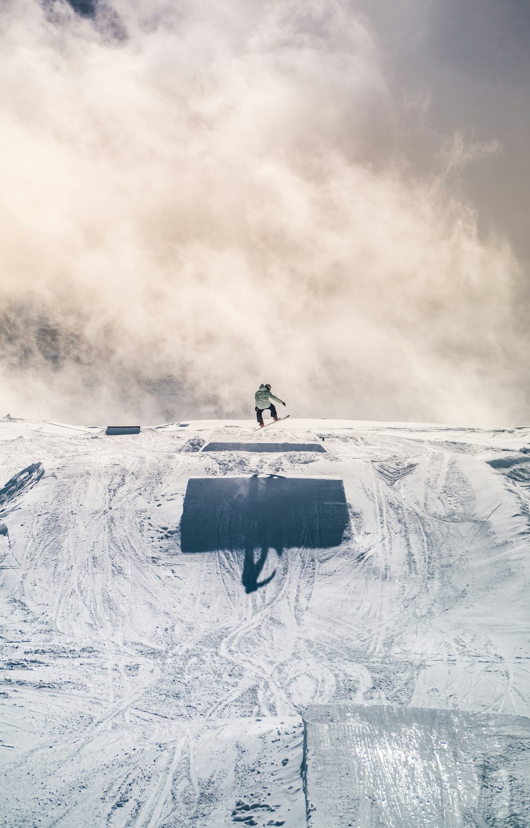 person in black jacket and pants walking on snow covered mountain during daytime