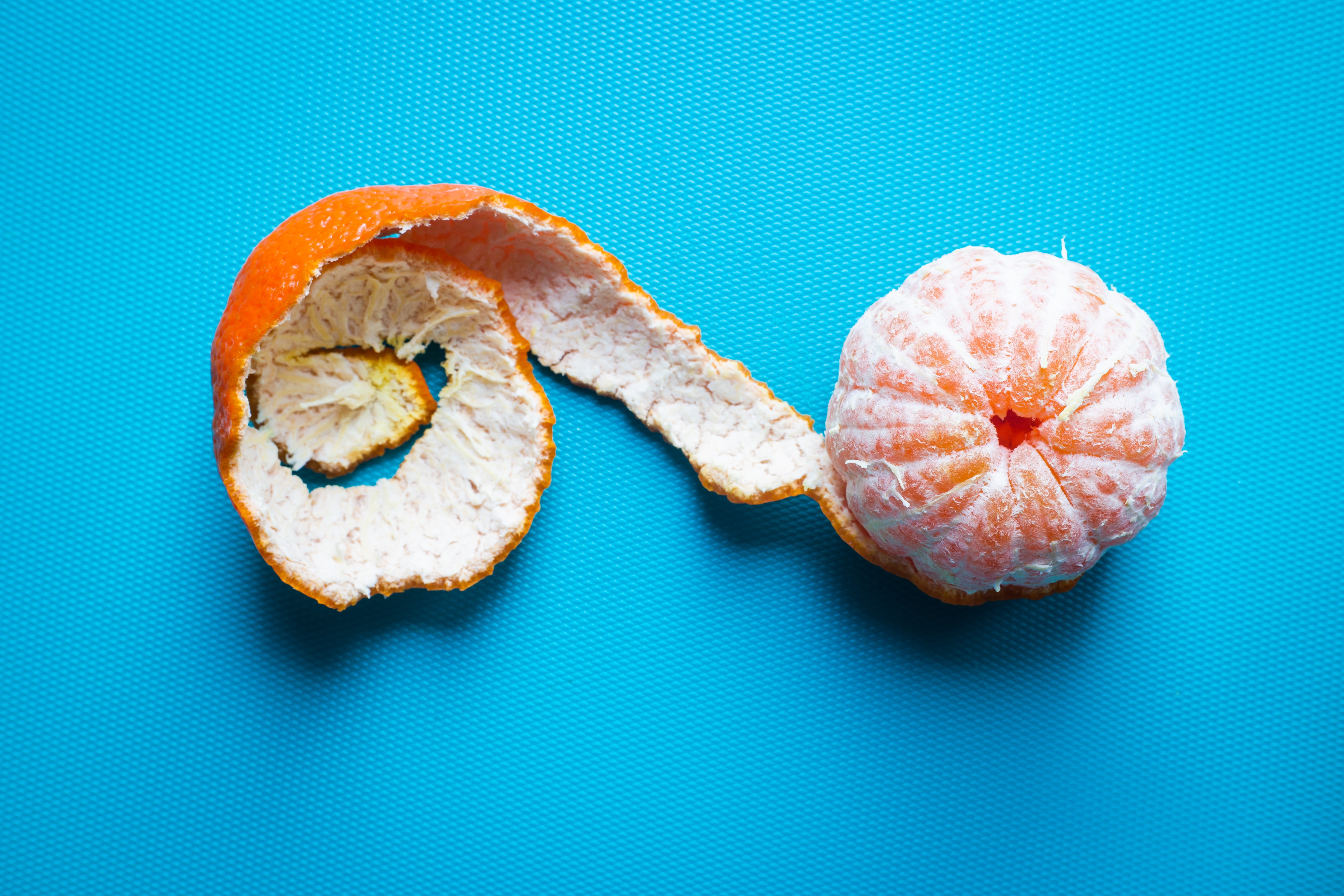 sliced orange fruit on blue textile