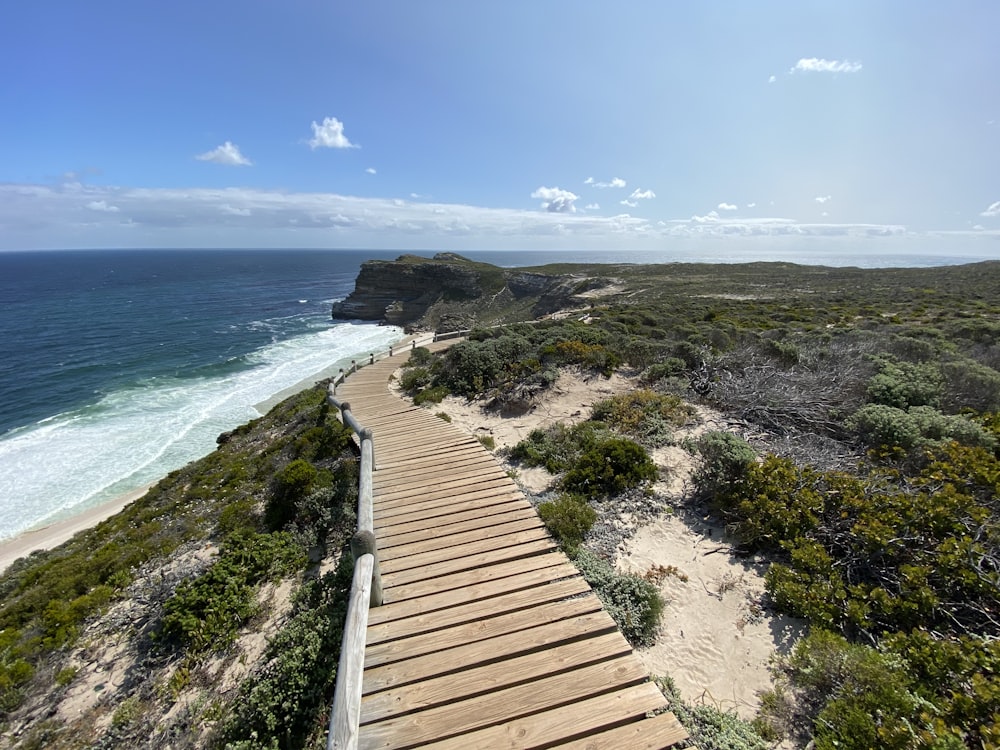 brown wooden dock on blue sea under blue sky during daytime