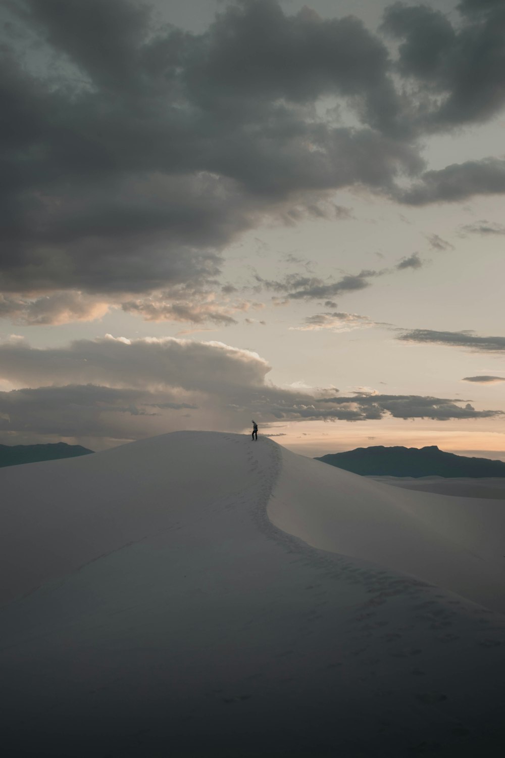 person standing on top of the mountain during daytime