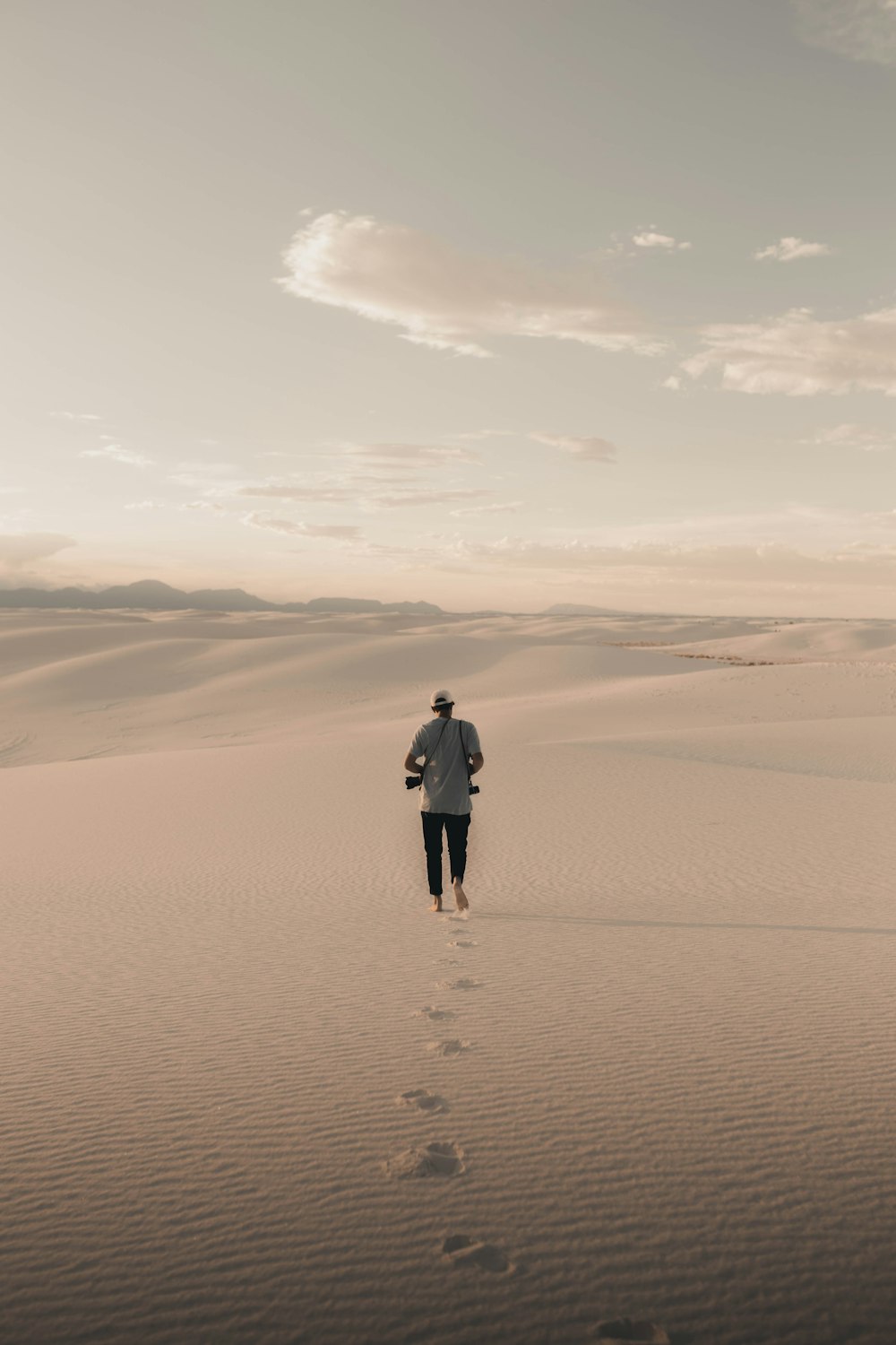 man and woman walking on desert during daytime