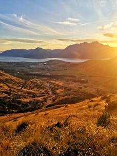 A film crew capturing a breathtaking landscape during golden hour.