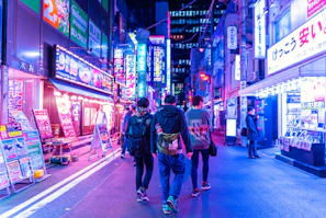 A lively street scene at night with neon signs and people enjoying the sonidero vibe.