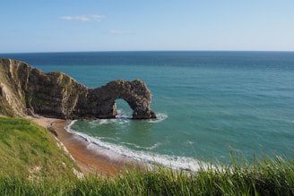 brown rock formation on sea during daytime