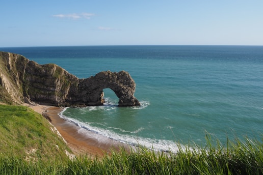 brown rock formation on sea during daytime