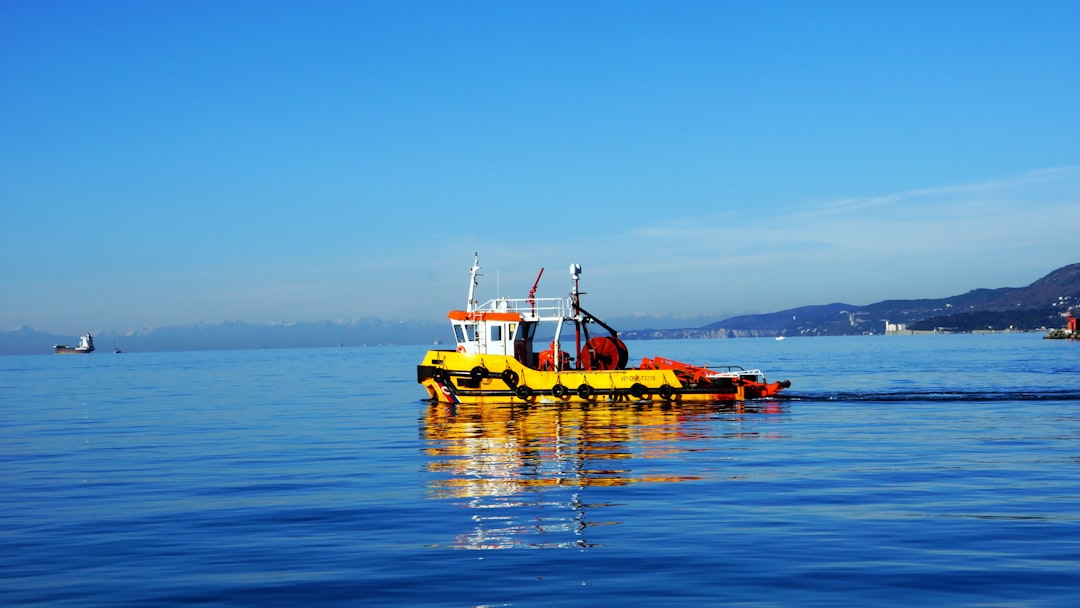 people in orange life vest riding yellow boat on sea during daytime