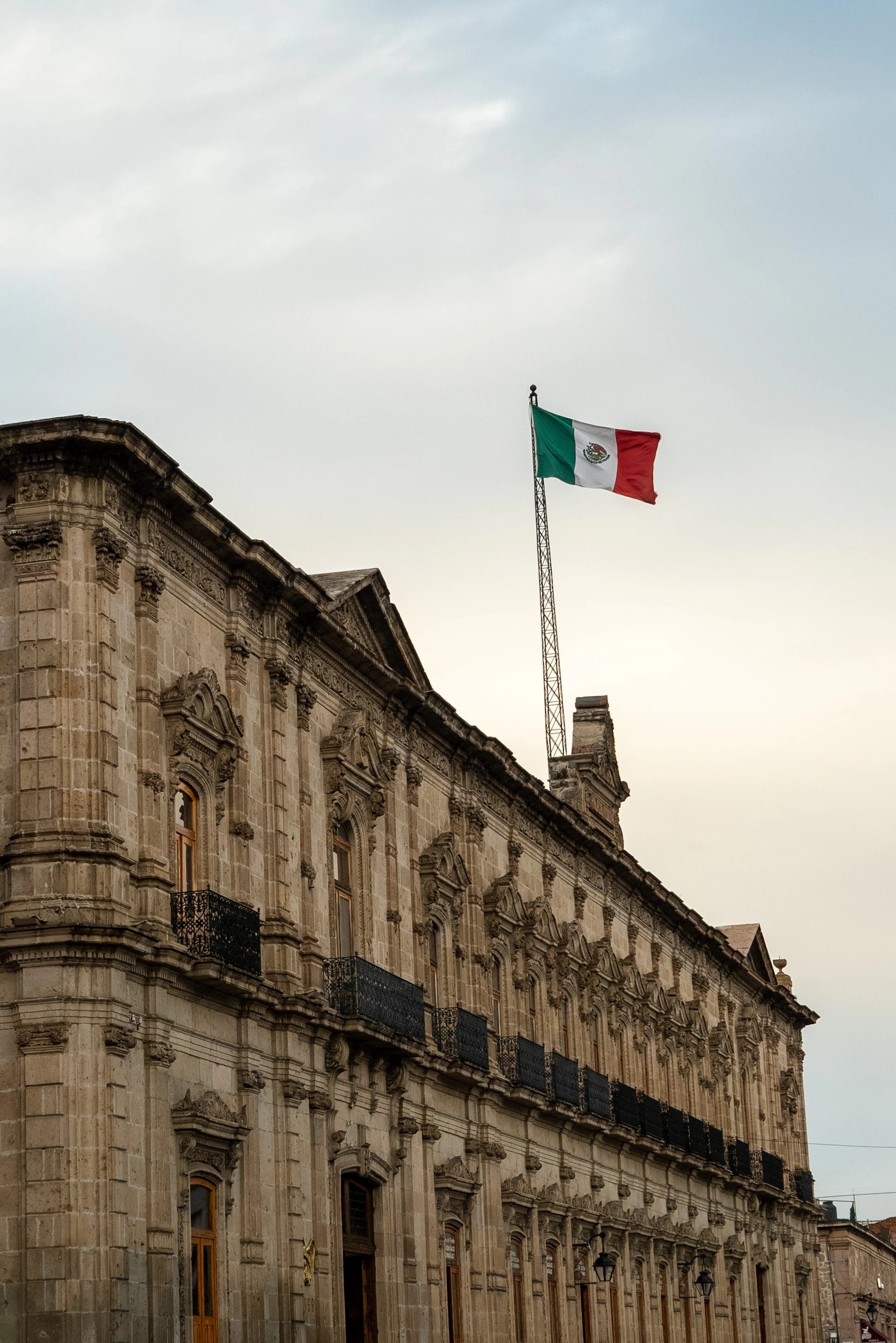 woman wearing yellow long-sleeved dress under white clouds and blue sky during daytime