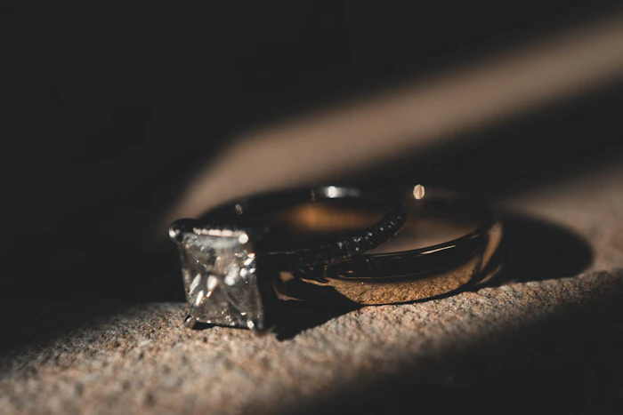 A silver ring resting on brown textile