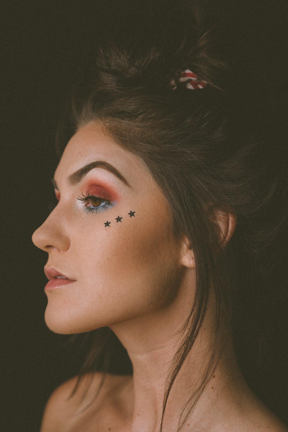 woman with red lipstick and black eyeshadow