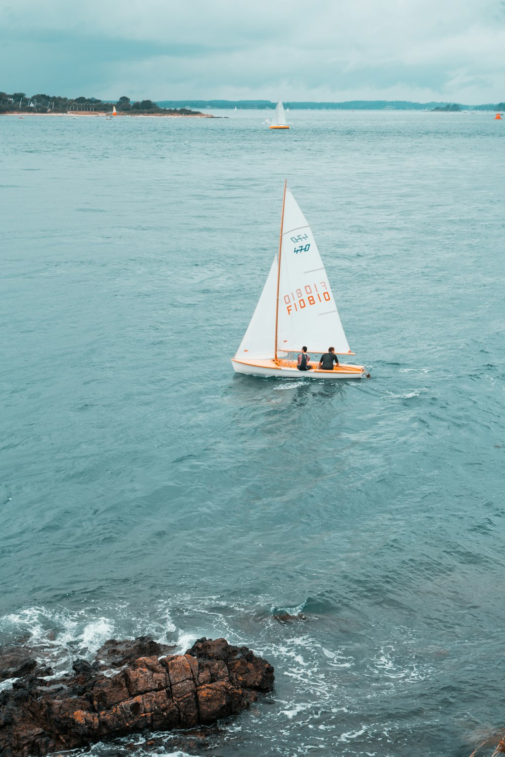 white and brown sailboat on sea during daytime
