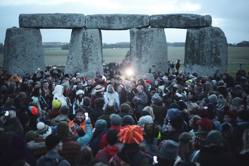 people gathering near gray concrete pillar during daytime