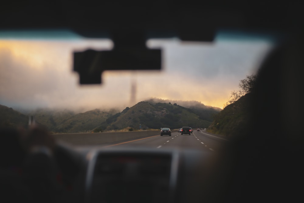 black framed sunglasses on car dashboard