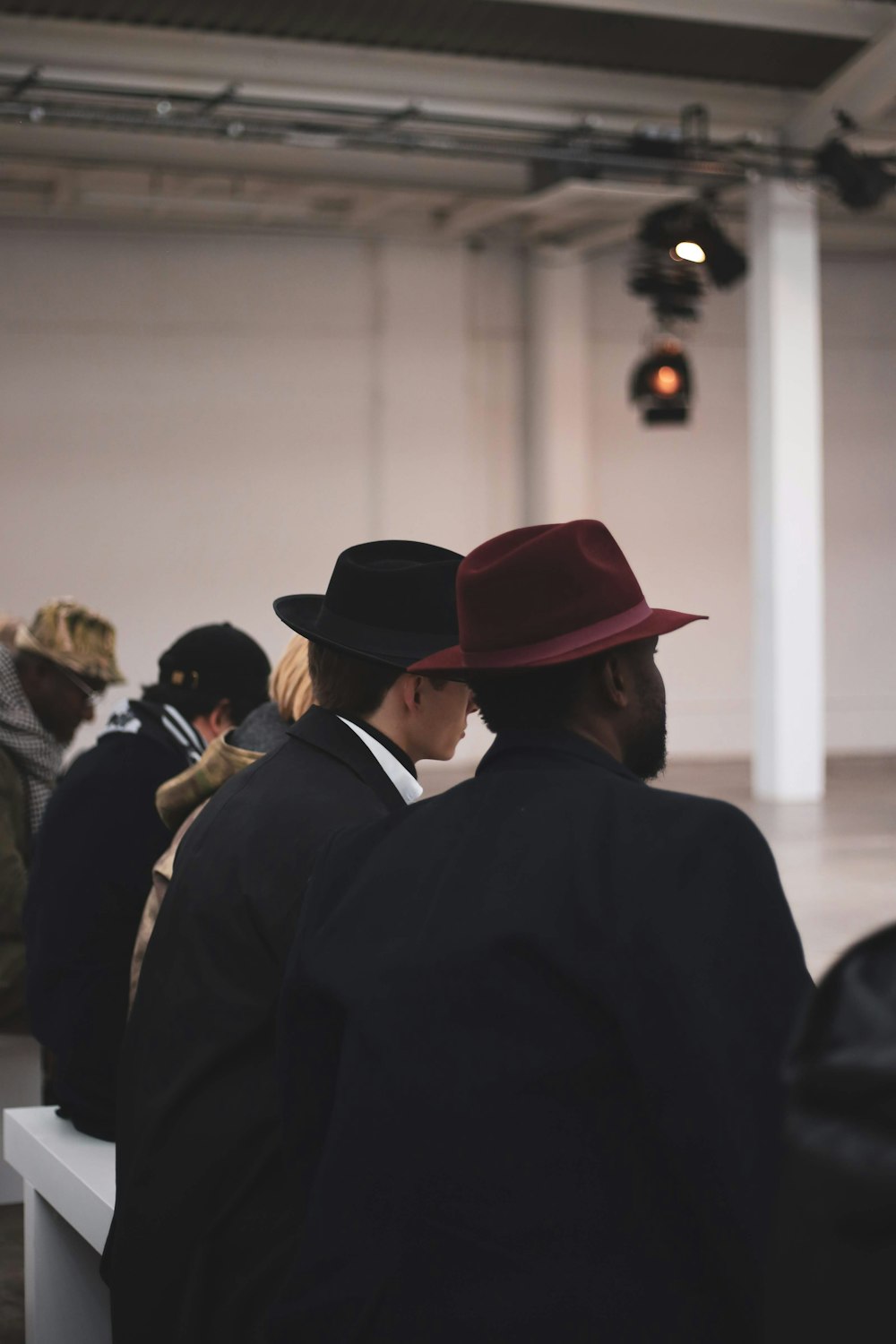 man in black suit wearing brown fedora hat