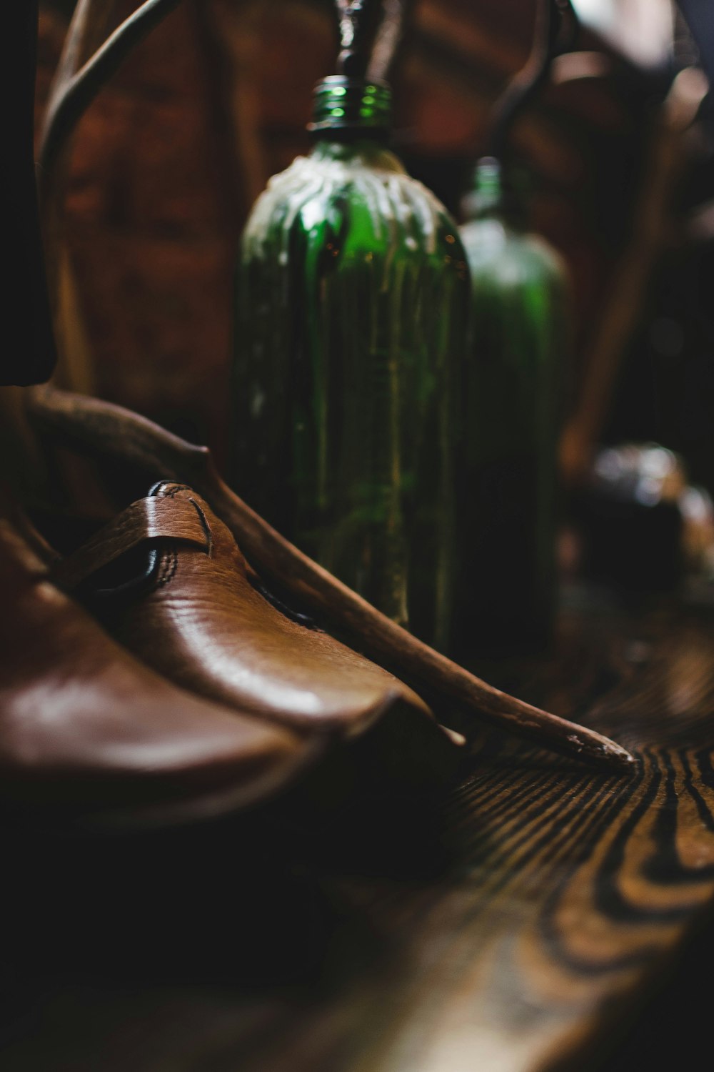 brown leather shoe on brown wooden table