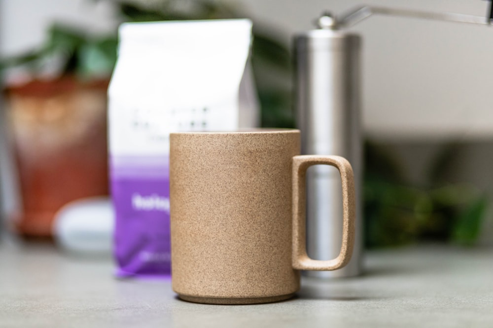 brown ceramic mug on purple table