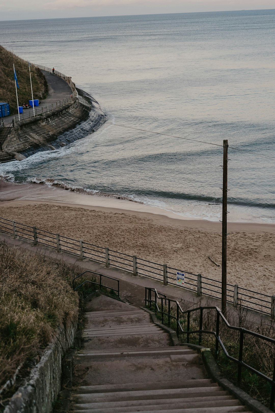 black metal fence near sea during daytime