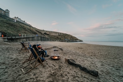 Evening firepit area with cozy seating, perfect for relaxing after a day at the beach.