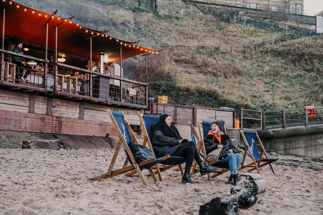 man and woman sitting on brown wooden folding chairs