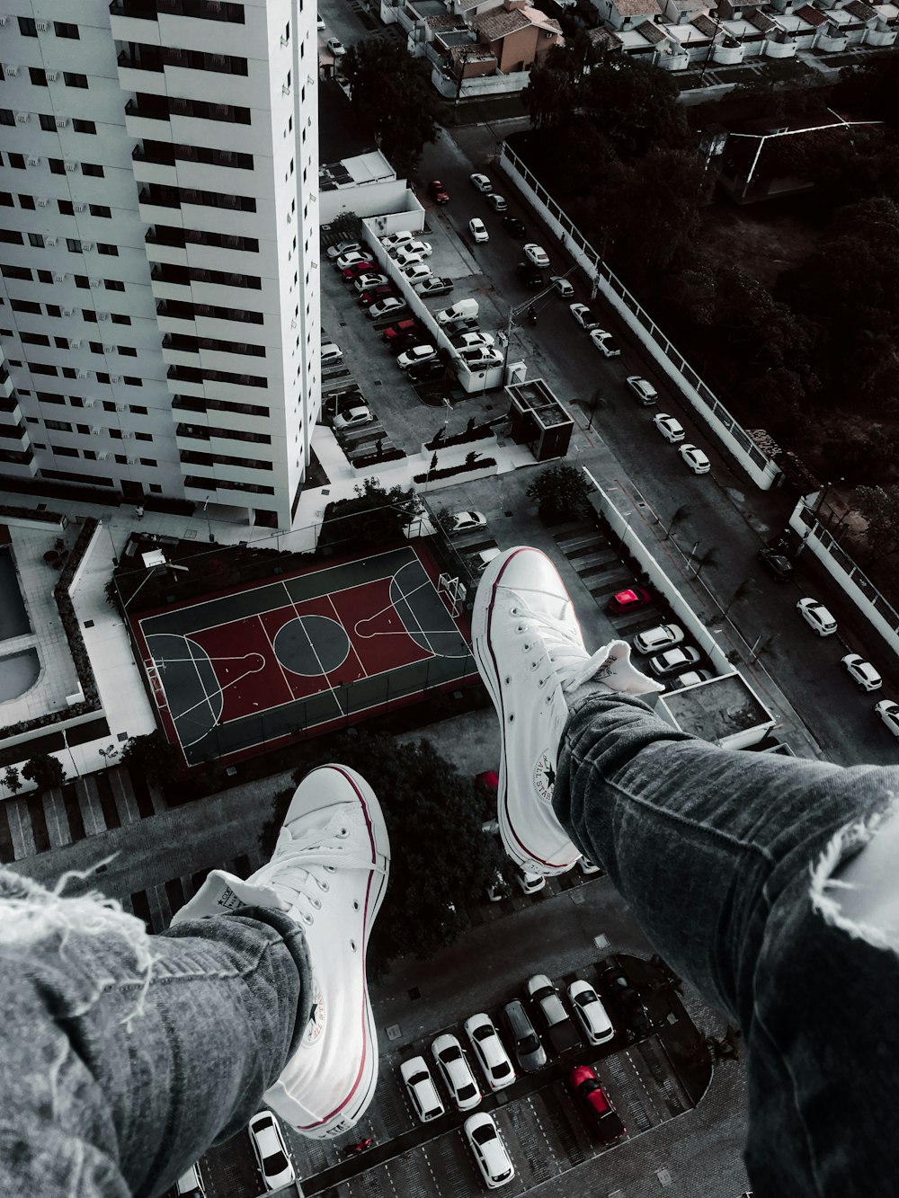 person in blue denim jeans and white sneakers