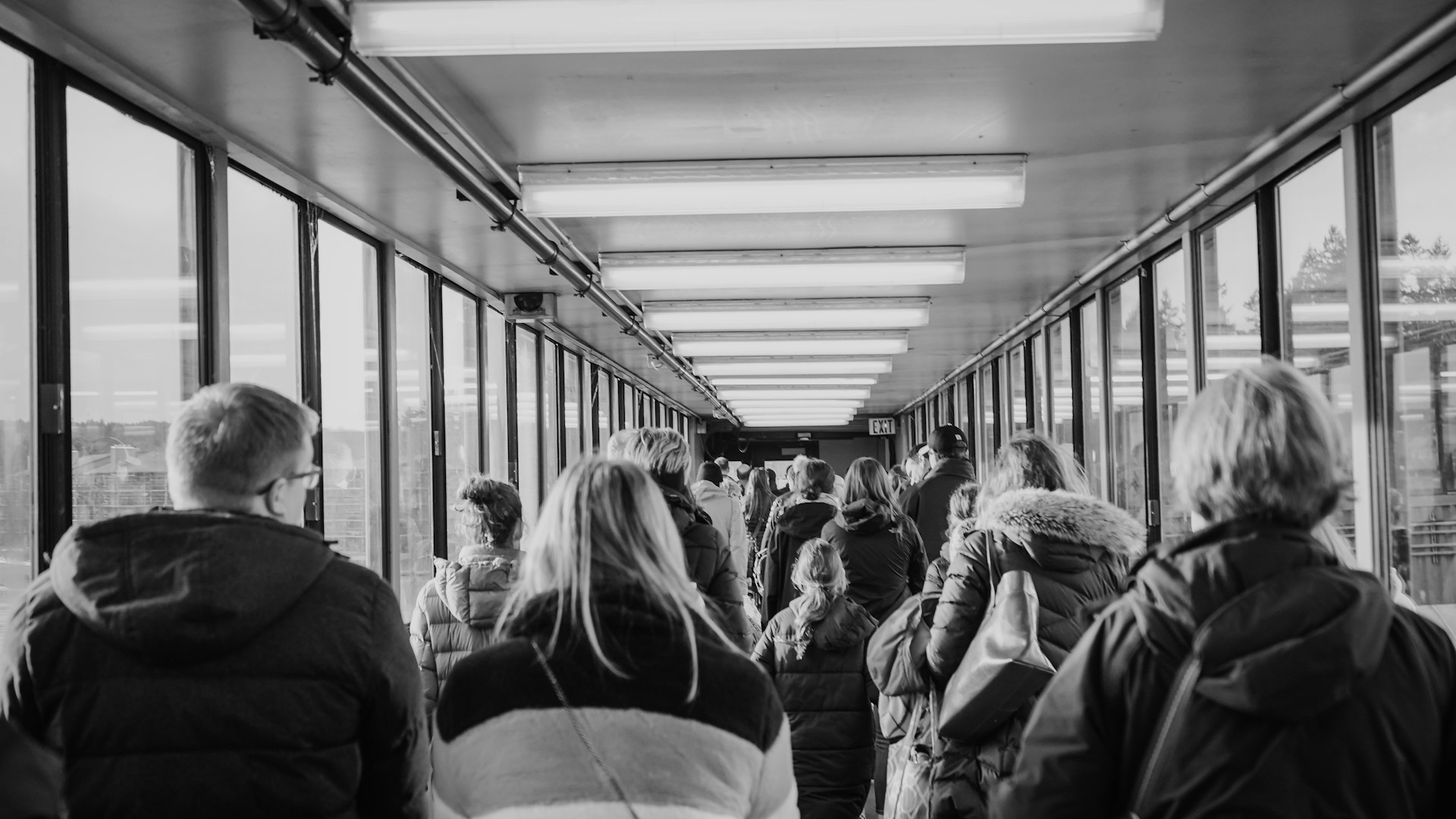 grayscale photo of people in train station