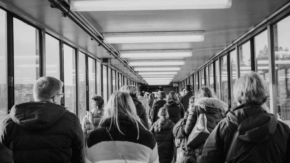 grayscale photo of people in train station