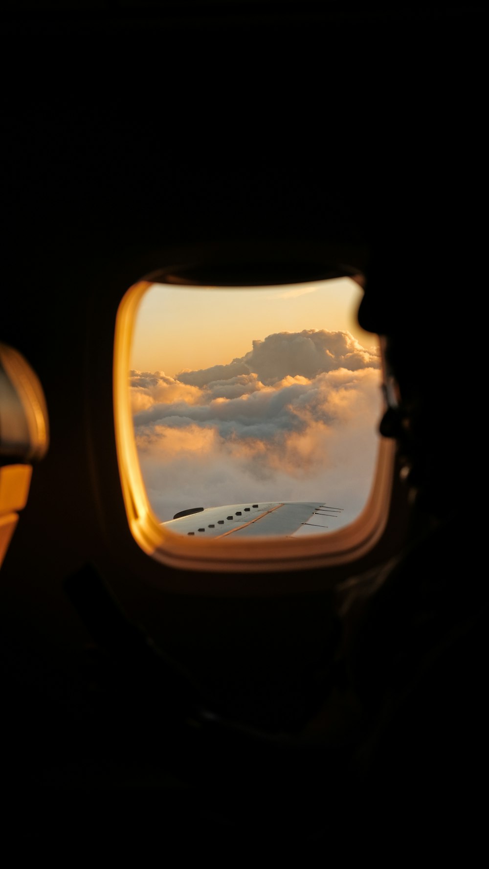 airplane window view of clouds during daytime