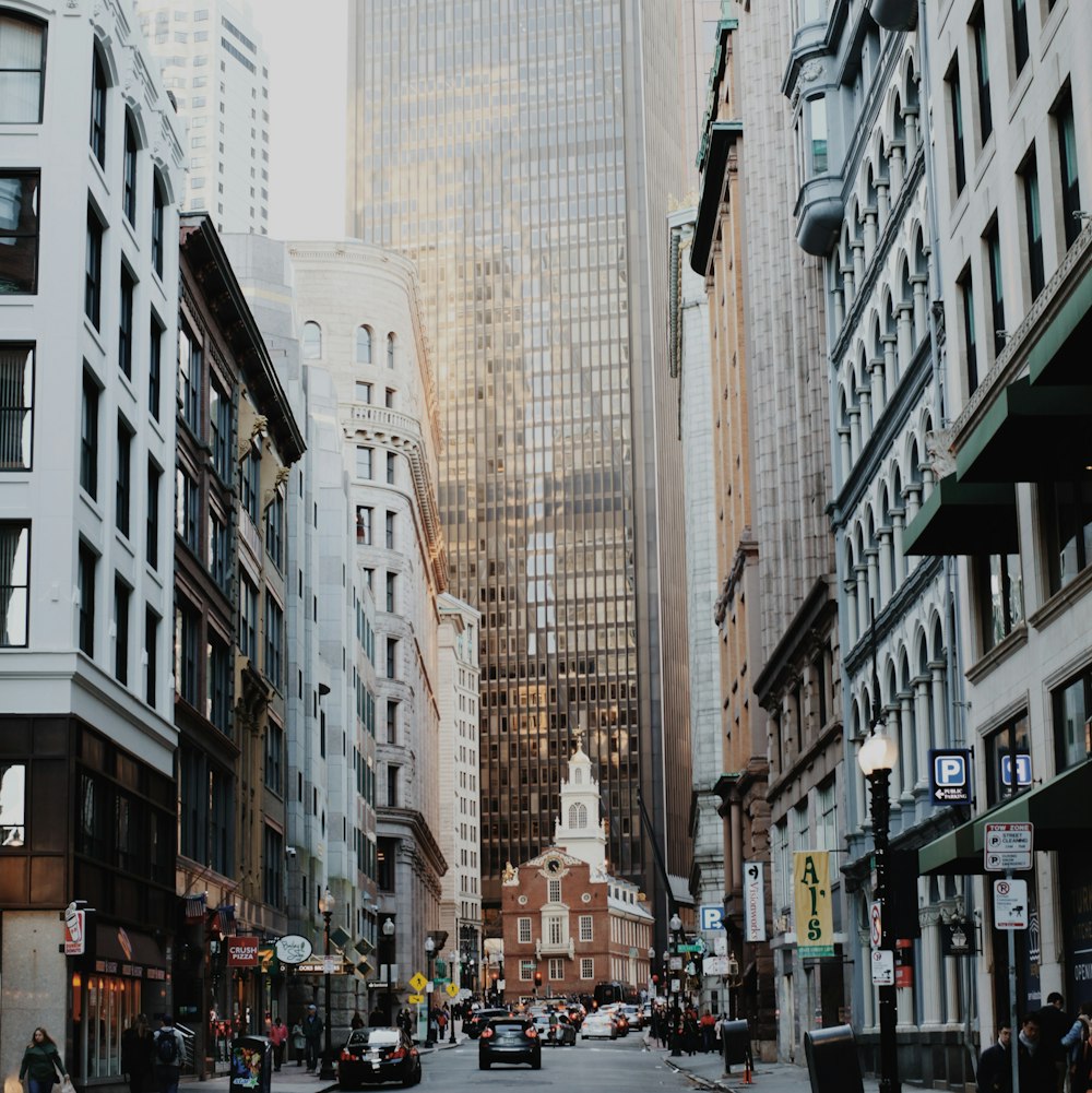 people walking on street between high rise buildings during daytime