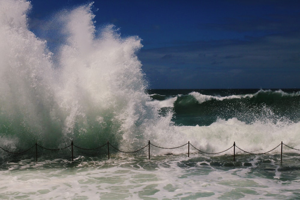 ocean waves crashing on shore during daytime