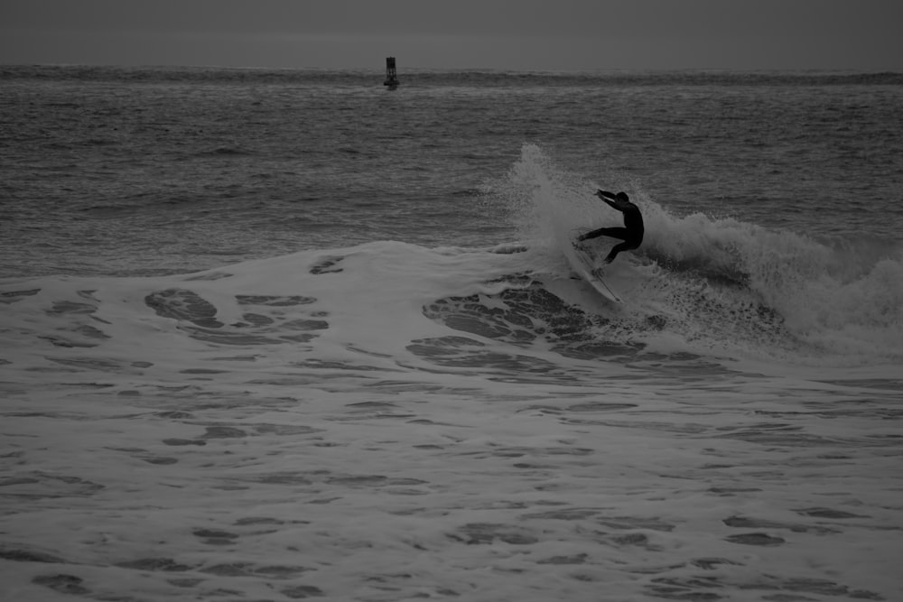 man surfing on sea waves during daytime