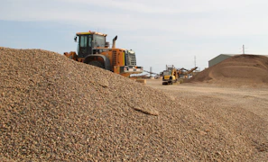 a large pile of dirt next to a bulldozer