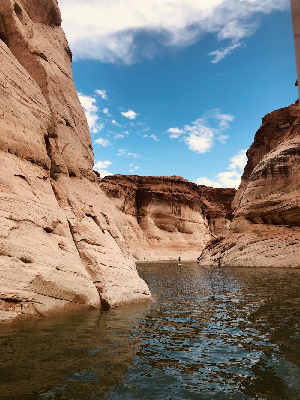 brown rock formation near body of water during daytime