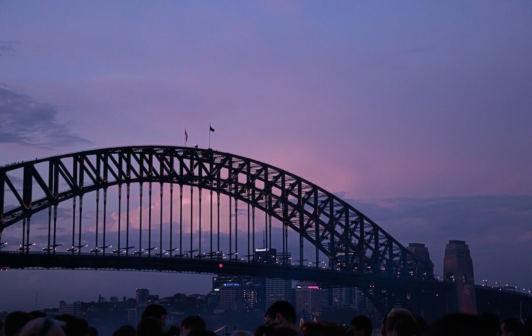 people walking on bridge during sunset