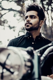 Confident person signing a credit application with a modern motorcycle in background.