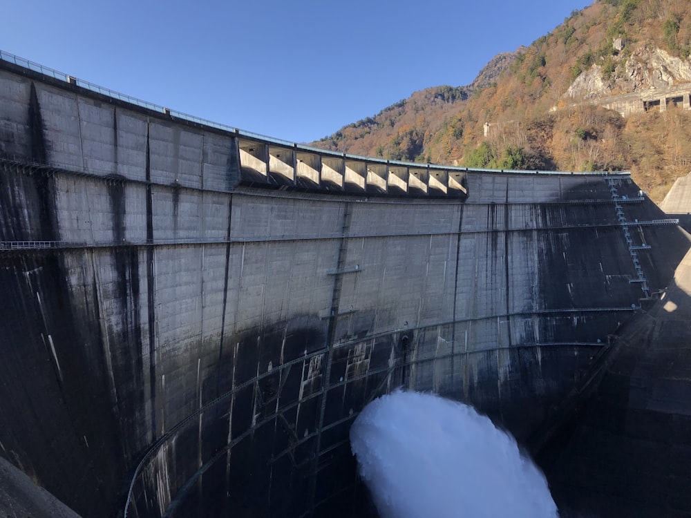 white water dam under blue sky during daytime