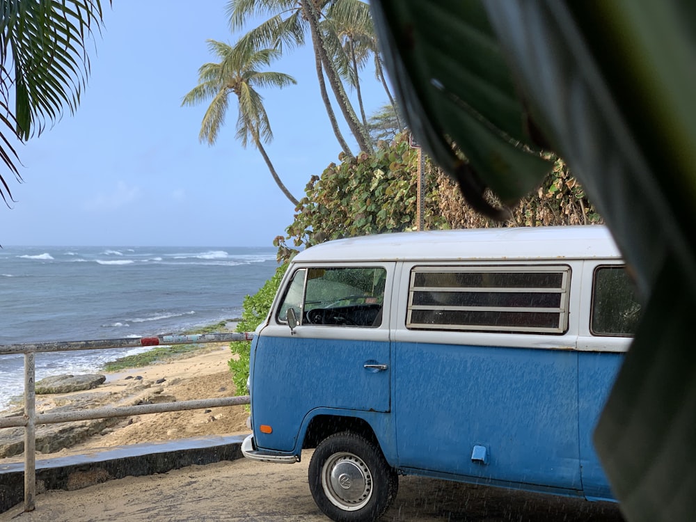 blue and white volkswagen t-2 parked on beach shore during daytime