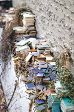 Close-up of hands laying vibrant floor tiles outdoors on a sunny day