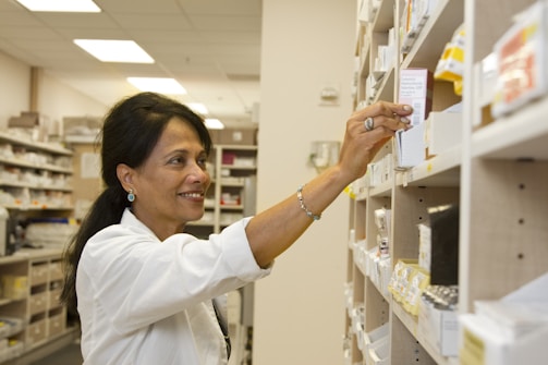 pharmacist placing item on shelf