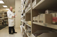 Warehouse staff carefully inspecting surgical supplies before dispatch.
