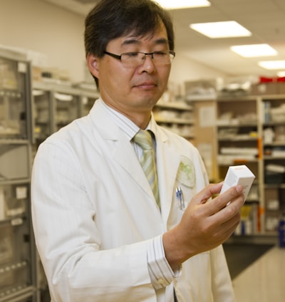 man in white dress shirt holding white card