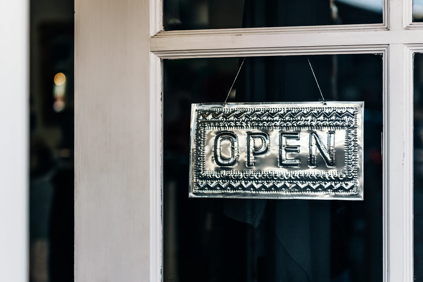 Welcome sign at a small-business entrance — loyalty customers who receive SMS marketing texts