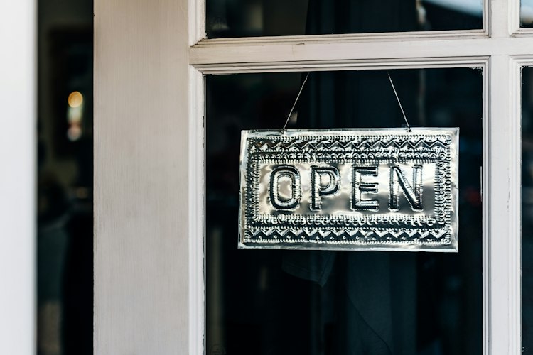 Small business storefront with an open sign in a local neighborhood