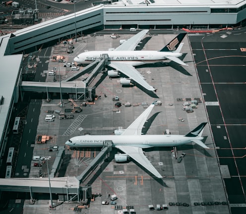 white and gray airplane on airport during daytime