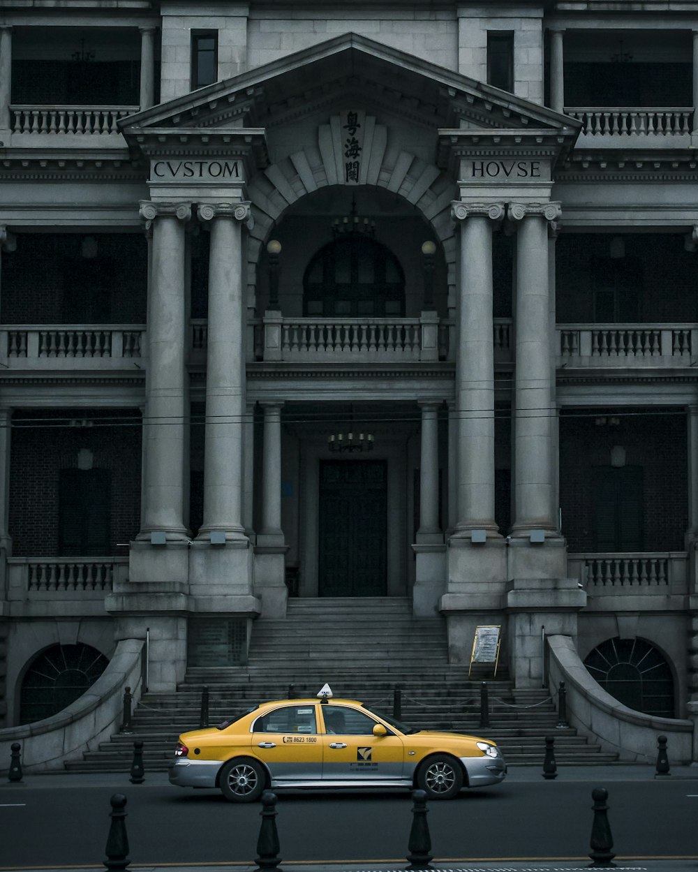 yellow porsche 911 parked near white concrete building during daytime