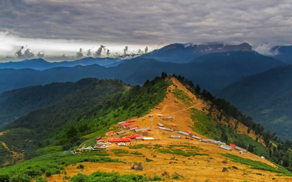 green and brown mountains under white clouds during daytime