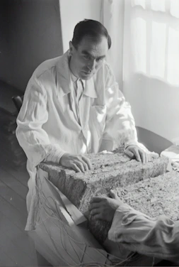 A modern laboratory setting with researchers examining porous materials under microscopes.